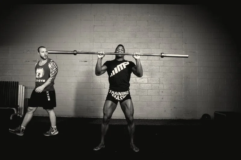 Craig coaching an athlete through an overhead lift